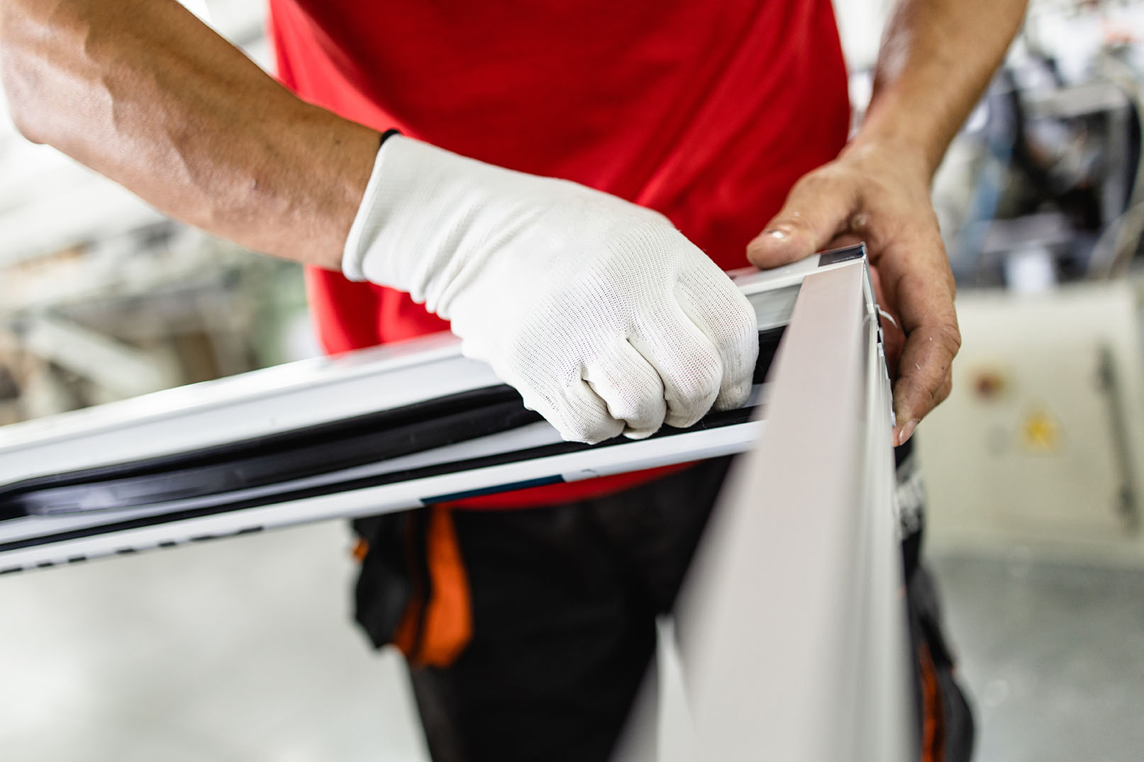 Manual worker assembling PVC doors and windows. Manufacturing jobs. Selective focus. Factory for aluminum and PVC windows and doors production.